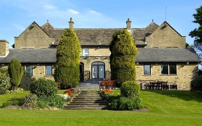 Beautiful garden with seating area at The Old Golf House Hotel.