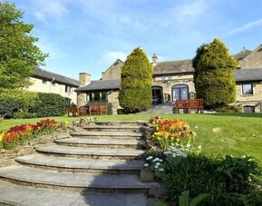Beautiful garden with seating area at The Old Golf House Hotel.
