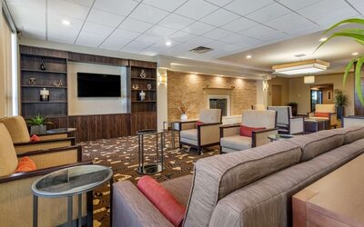Lobby with comfortable seating and a television at Comfort Inn Glenmont - Albany South.