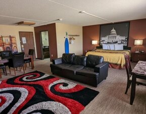 Day room with a couch and workspace at Coratel Inn And Suites By Jasper Wichita North