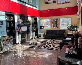 Lobby with comfortable seating at Coratel Inn And Suites By Jasper Wichita North.