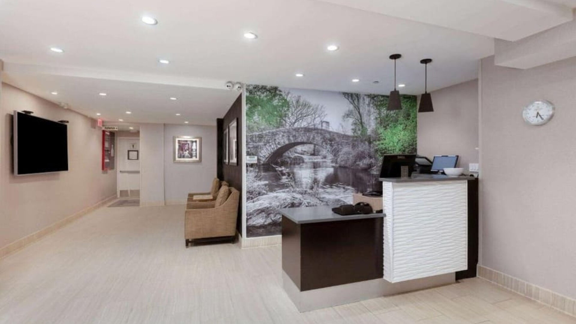 Welcoming reception area with comfortable seating at La Quinta Inn & Suites By Wyndham New York City Central Park.