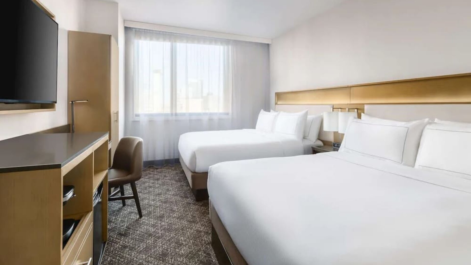 Guest room in the DoubleTree Times Square South, with a workspace desk and chair.