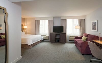 Day use room with a couch. work desk and chair at the Hampton Inn Times Square South. 