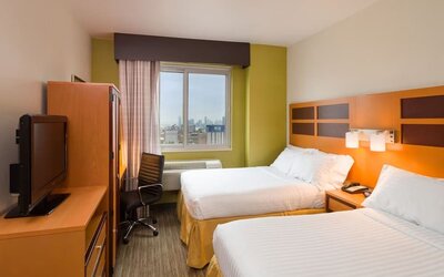 Day room at the Holiday Inn Express Times Square’s with workspace and a televison.