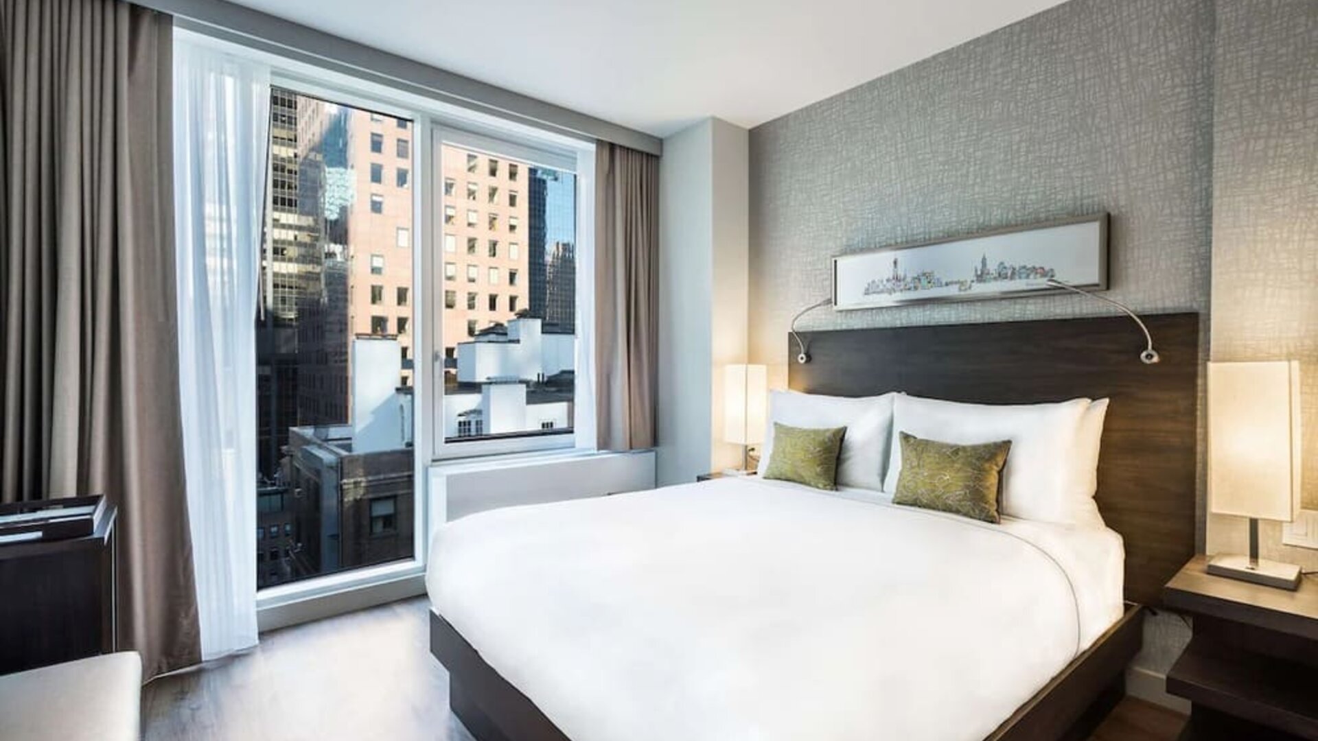 Day use room with large windows providing a beautiful view of the city at The Bernic Hotel New York City, Tapestry Collection By Hilton.