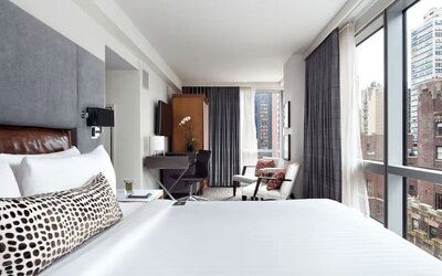 Day use room with workspace, large windows and natural light at Hotel 48LEX New York.