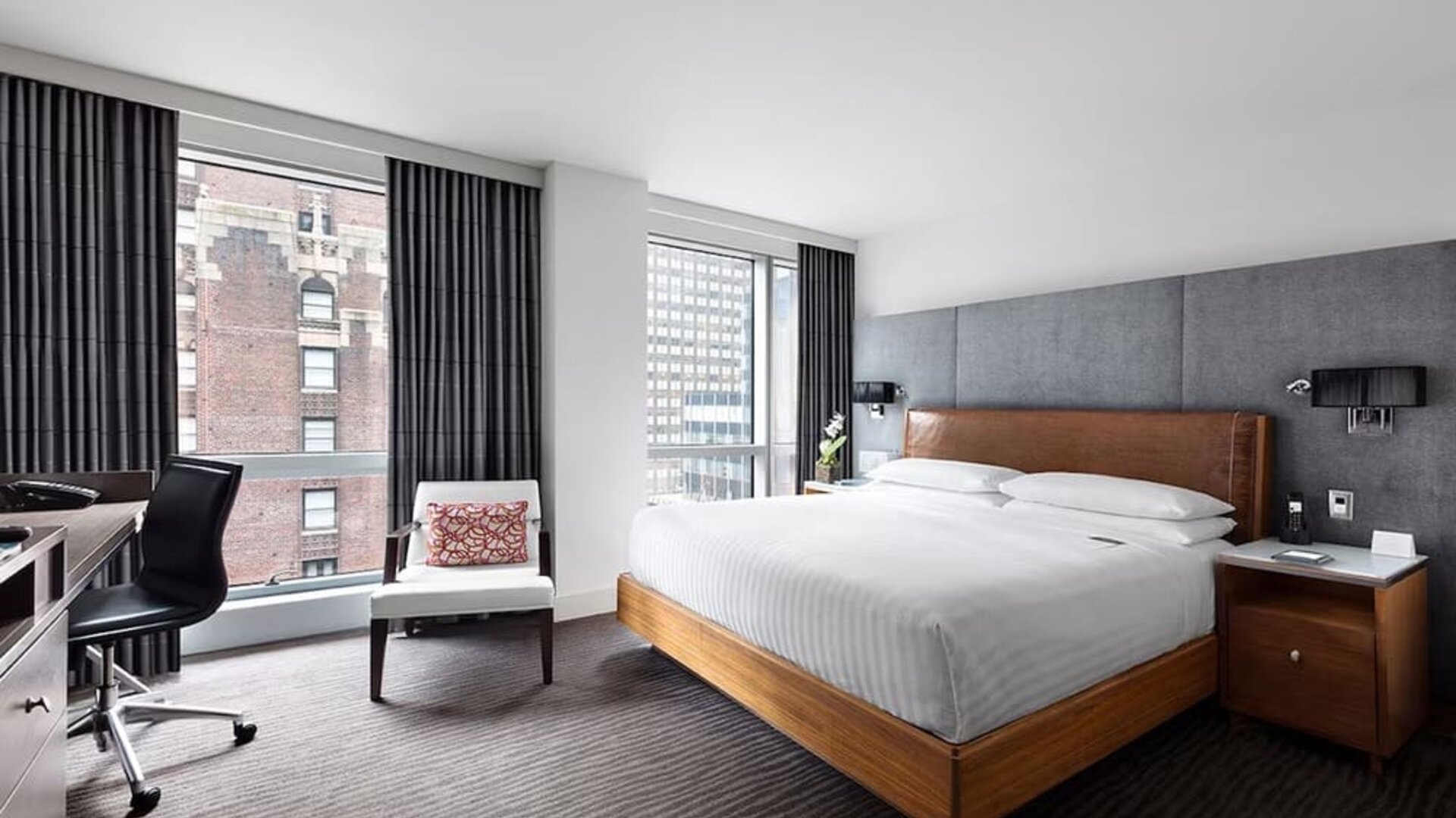 Day use room with workspace, large windows and natural light at Hotel 48LEX New York.