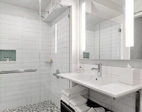 Modern bathroom with plush towels at Hotel 48LEX New York.