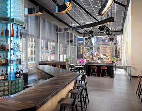 Stylish bar at M Social Hotel Times Square   ideal for unwinding after a busy day.