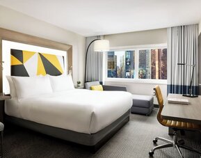 Day use room with workspace and natural light at M Social Hotel Times Square.