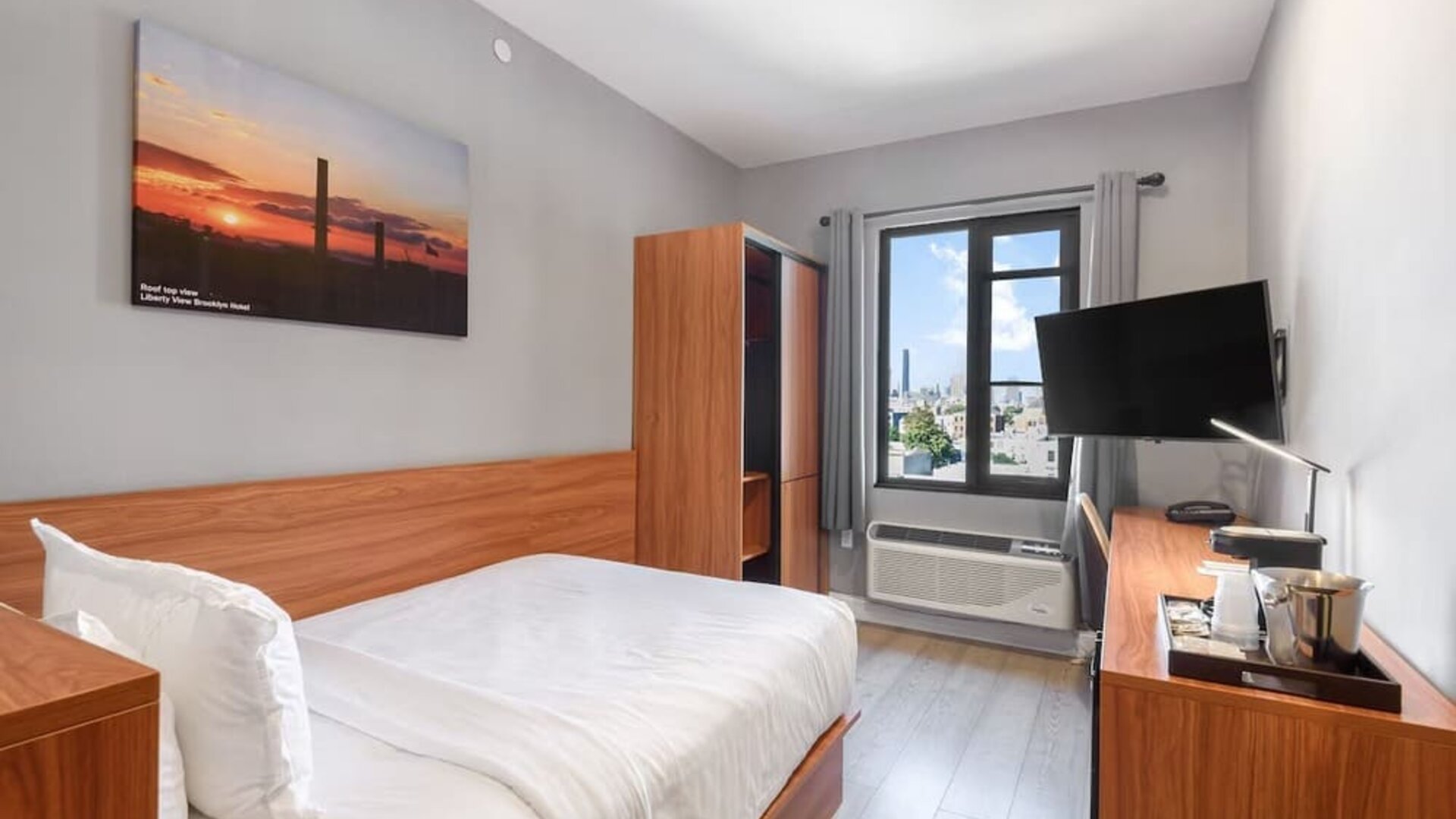 Day use room with work desk and natural light at Liberty View Brooklyn Hotel.