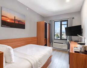 Day use room with work desk and natural light at Liberty View Brooklyn Hotel.