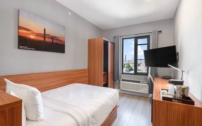 Day use room with work desk and natural light at Liberty View Brooklyn Hotel.
