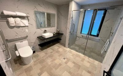 Modern bathroom with plush towels at Liberty View Brooklyn Hotel.