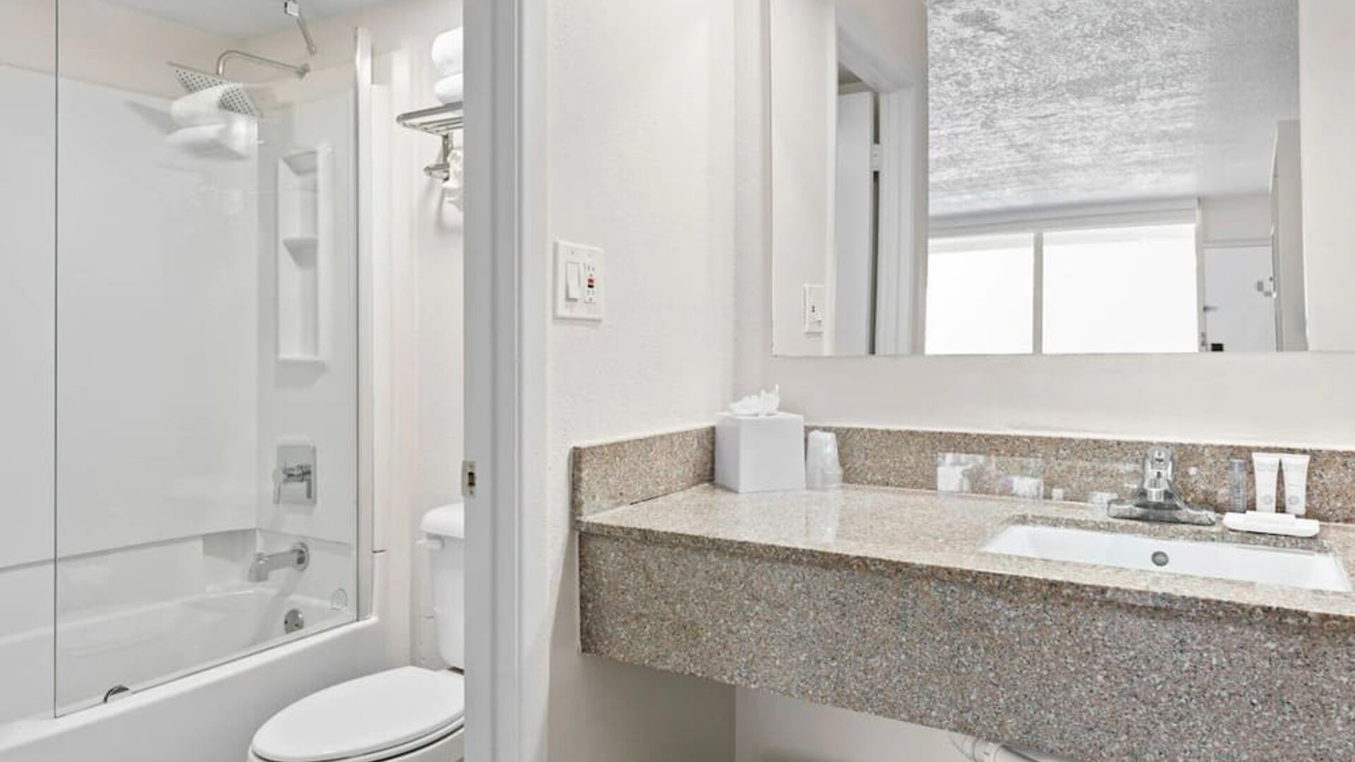 Modern bathroom with towels at Baymont by Wyndham Maingate.