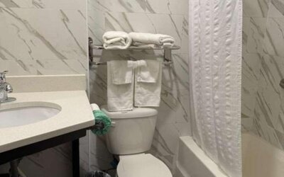 Bathroom with towels at Days Inn By Wyndham Brooklyn Marine Park.