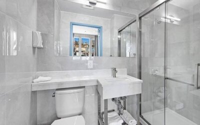 Modern bathroom with towels at Hotel 365 Bronx.