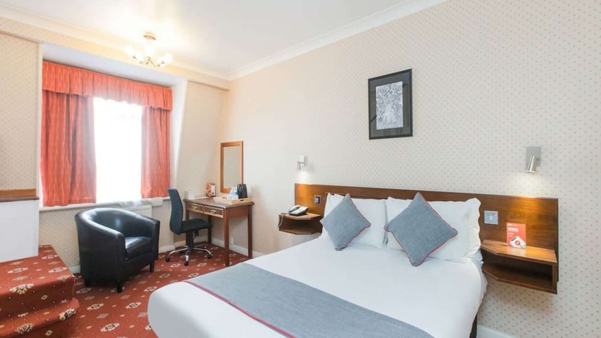 Day room with workspace and a couch at Stade Court Hotel.