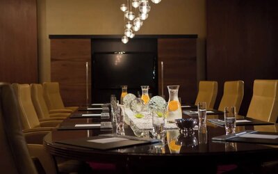 Boardroom with long table, chairs and decorative lighting at Renaissance Newark Airport Hotel.