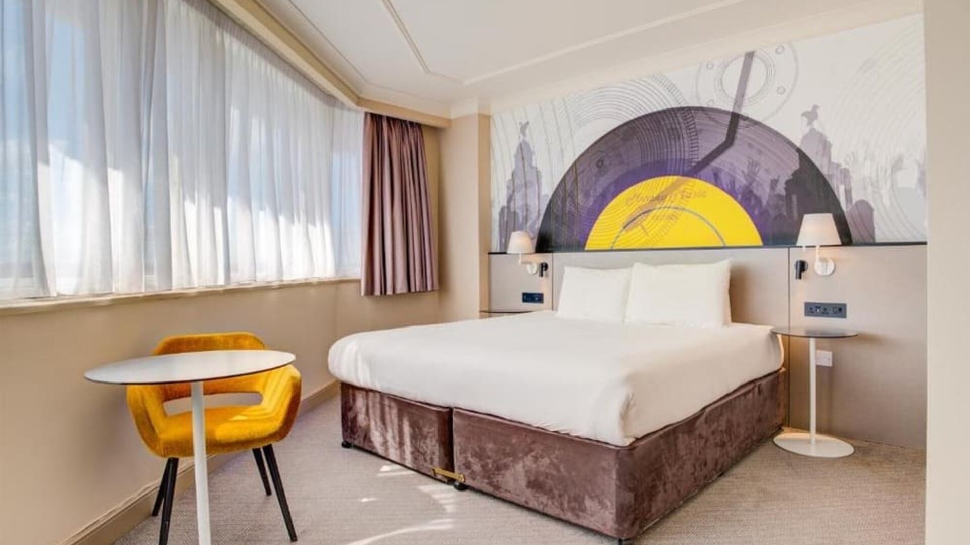 Spacious double room with large bed, side tables, and seating area by the window at Atlantic Tower Hotel Liverpool By Sunday.