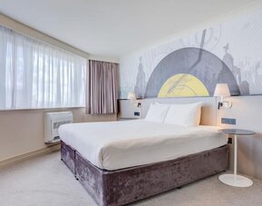 Bright double room with large windows, wall mural, and bedside lighting at Atlantic Tower Hotel Liverpool By Sunday.