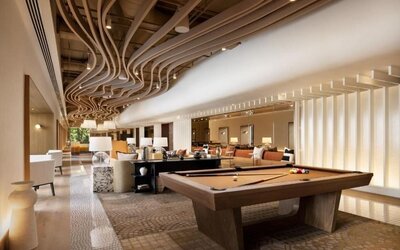 Lounge area with pool table, open seating, and modern ceiling design at M Social New York Downtown.