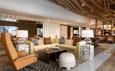 Stylish lobby lounge with sofas, marble tables, decorative lighting, and contemporary design at M Social New York Downtown.