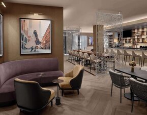 Lounge and bar area with seating, tables, and dining space at Hilton Brooklyn New York.