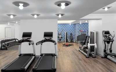 Fitness center with treadmills, weight machines, and free weights at Le Méridien New York, Central Park.
