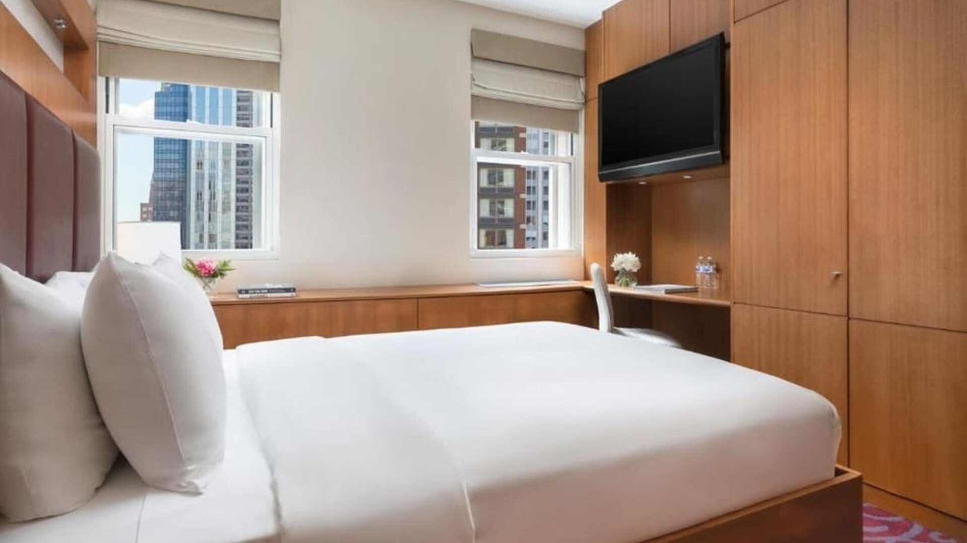 Guest room with king bed, workspace, and city views at Hotel 57.