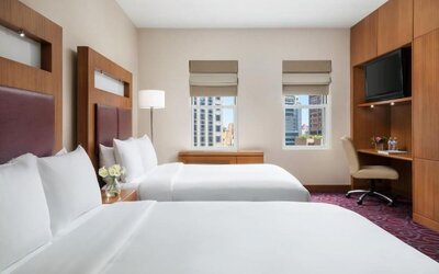 Guest room with two beds and workspace at Hotel 57.