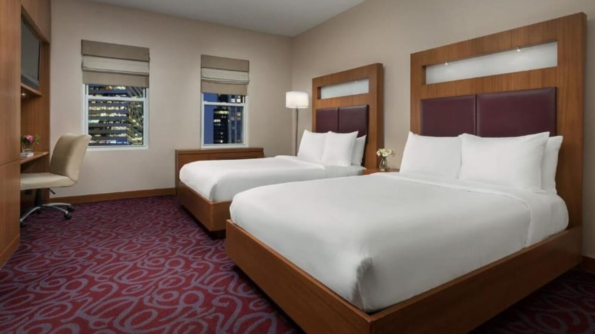 Guest room with two beds and workspace at Hotel 57.