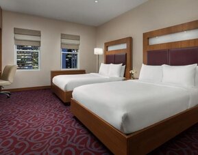 Guest room with two beds and workspace at Hotel 57.