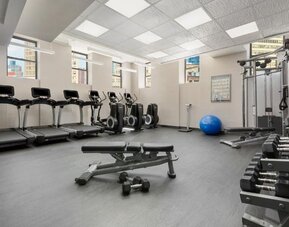 Fitness center with treadmills, weights, and strength equipment at Hotel 57.
