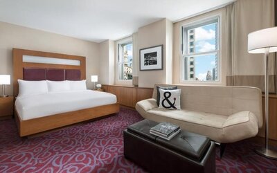 Guest room with sofa seating and natural light at Hotel 57.