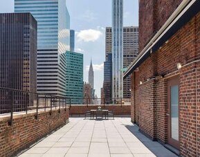 Rooftop terrace with skyline views and outdoor seating at Hotel 57.