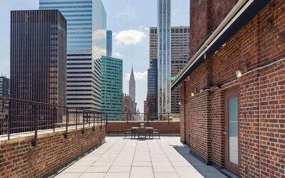 Rooftop terrace with skyline views and outdoor seating at Hotel 57.