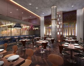 Restaurant interior with contemporary design, warm lighting, and spacious seating at Hotel Hendricks.