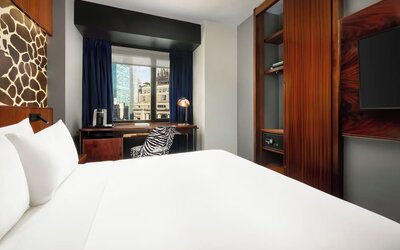 King room with modern furnishings, wardrobe space, and workspace with city views at Hotel Hendricks.
