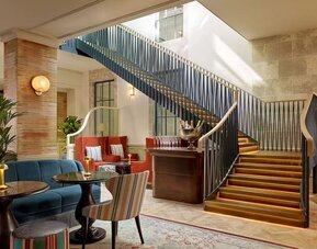 Hotel reception and stairway at 100 Queen's Gate Hotel London.