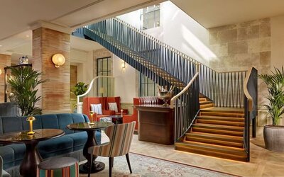 Hotel reception and stairway at 100 Queen's Gate Hotel London.