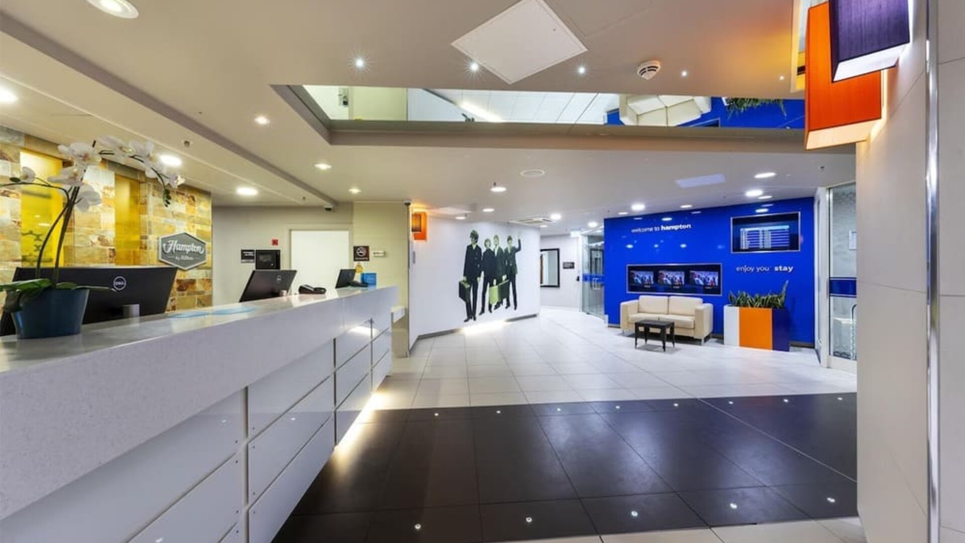 Hotel reception wit Beatles wall design at Hampton By Hilton Liverpool/John Lennon Airport.