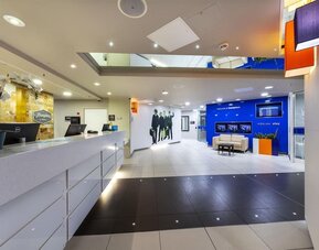 Hotel reception wit Beatles wall design at Hampton By Hilton Liverpool/John Lennon Airport.