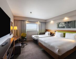 Two queen beds with TV and work desk at Hampton By Hilton Liverpool/John Lennon Airport.