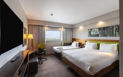 Two queen beds with TV and work desk at Hampton By Hilton Liverpool/John Lennon Airport.