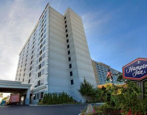 Tall hotel exterior at Hampton Inn NY-JFK.