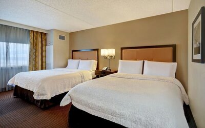 Day use room with two beds and natural light at Hampton Inn NY-JFK.