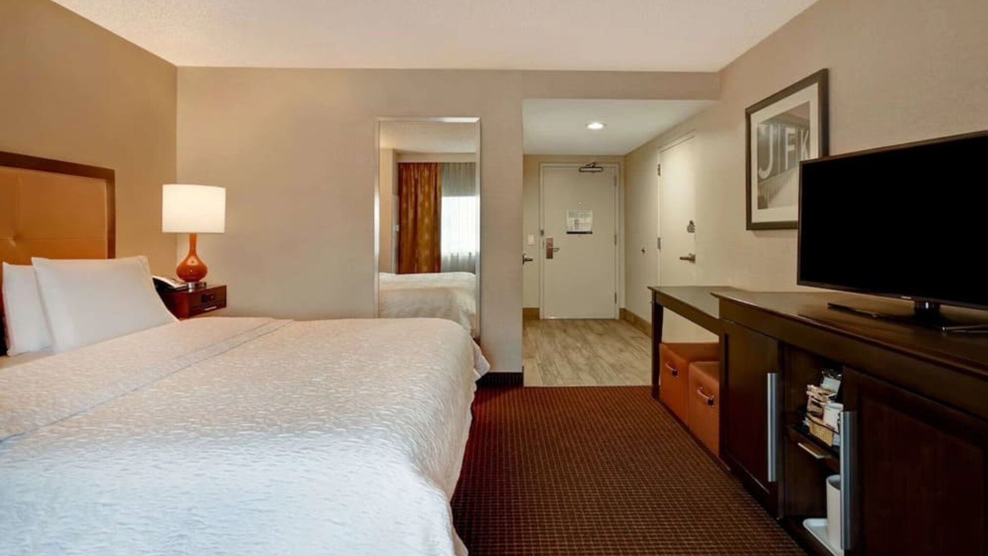 King room with TV and private bathroom at Hampton Inn NY-JFK.