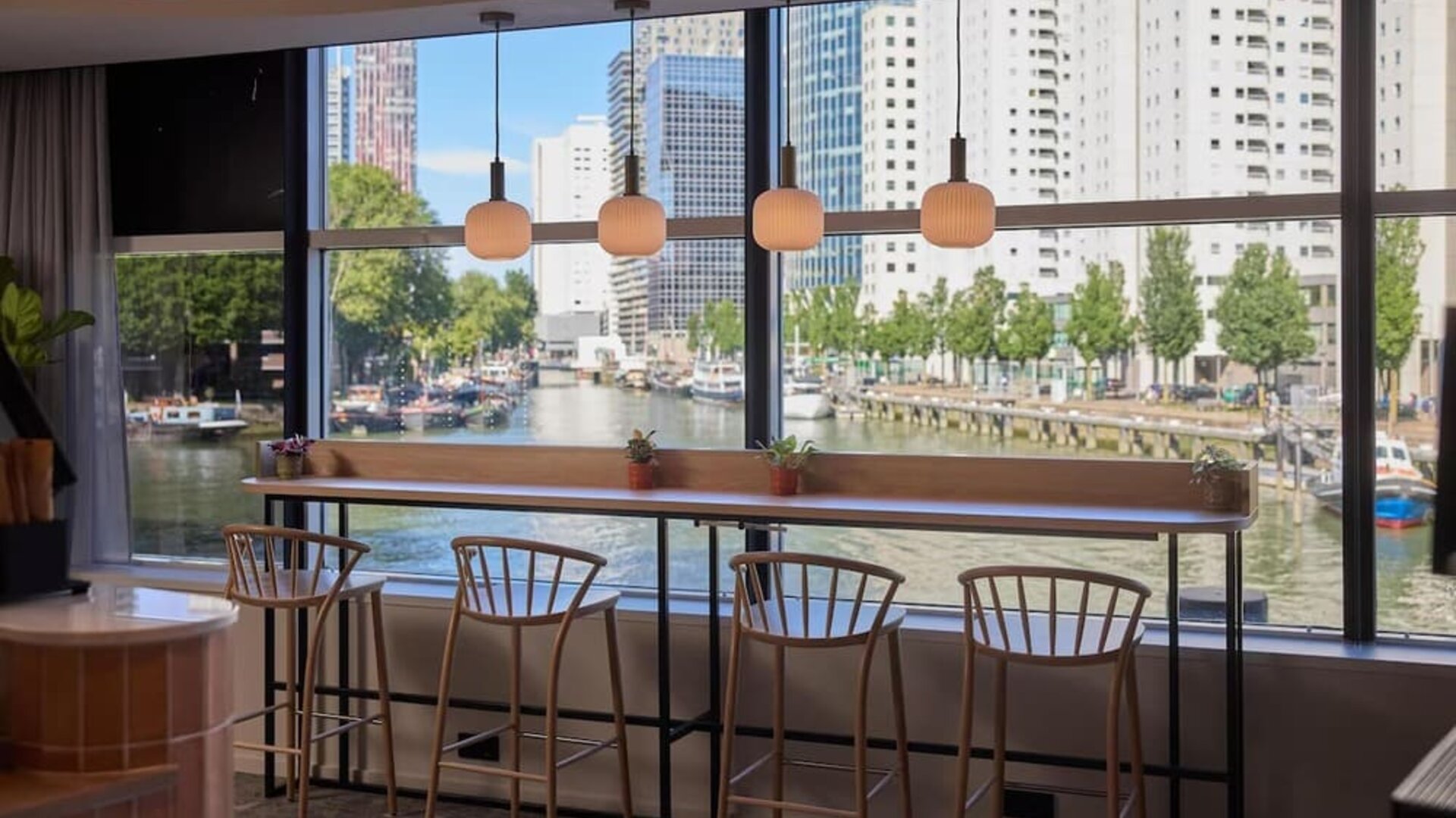Bar seating with canal views at Haven Hotel Rotterdam.